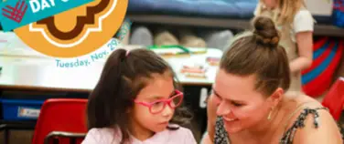 The Francis Parker School Giving Day campaign page featuring a teacher smiling and helping a student at a desk.