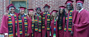 The St. Andrew's Episcopal School social fundraising campaign page featuring graduates in caps and gowns.