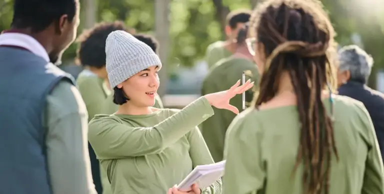 Woman outdoors directing community volunteers.