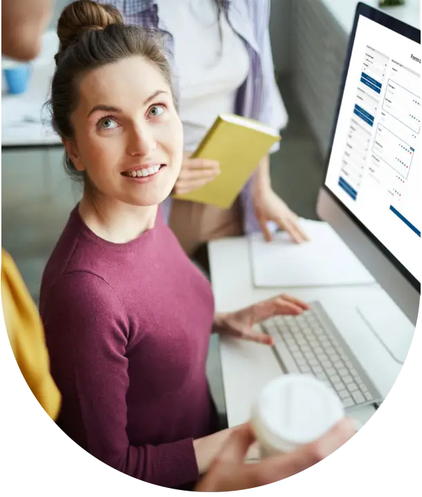 Woman administrator talking to colleague as she builds a custom giving form on the GiveCampus platform.