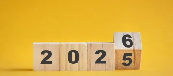 2025 turn to 2026, square blocks isolated on yellow surface.
