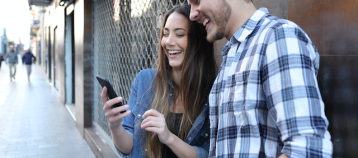 Two teenagers looking at a smartphone