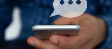 Hand of man typing text on mobile smartphone.