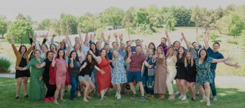 Group shot of GiveCampus team celebrating outdoors at retreat in Charlottesville.