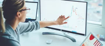 Woman studying data charts on a computer