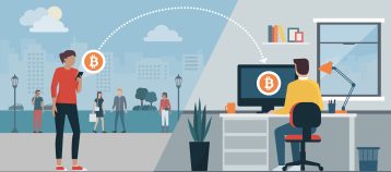 Woman sending bitcoins to another user's computer using a mobile app.